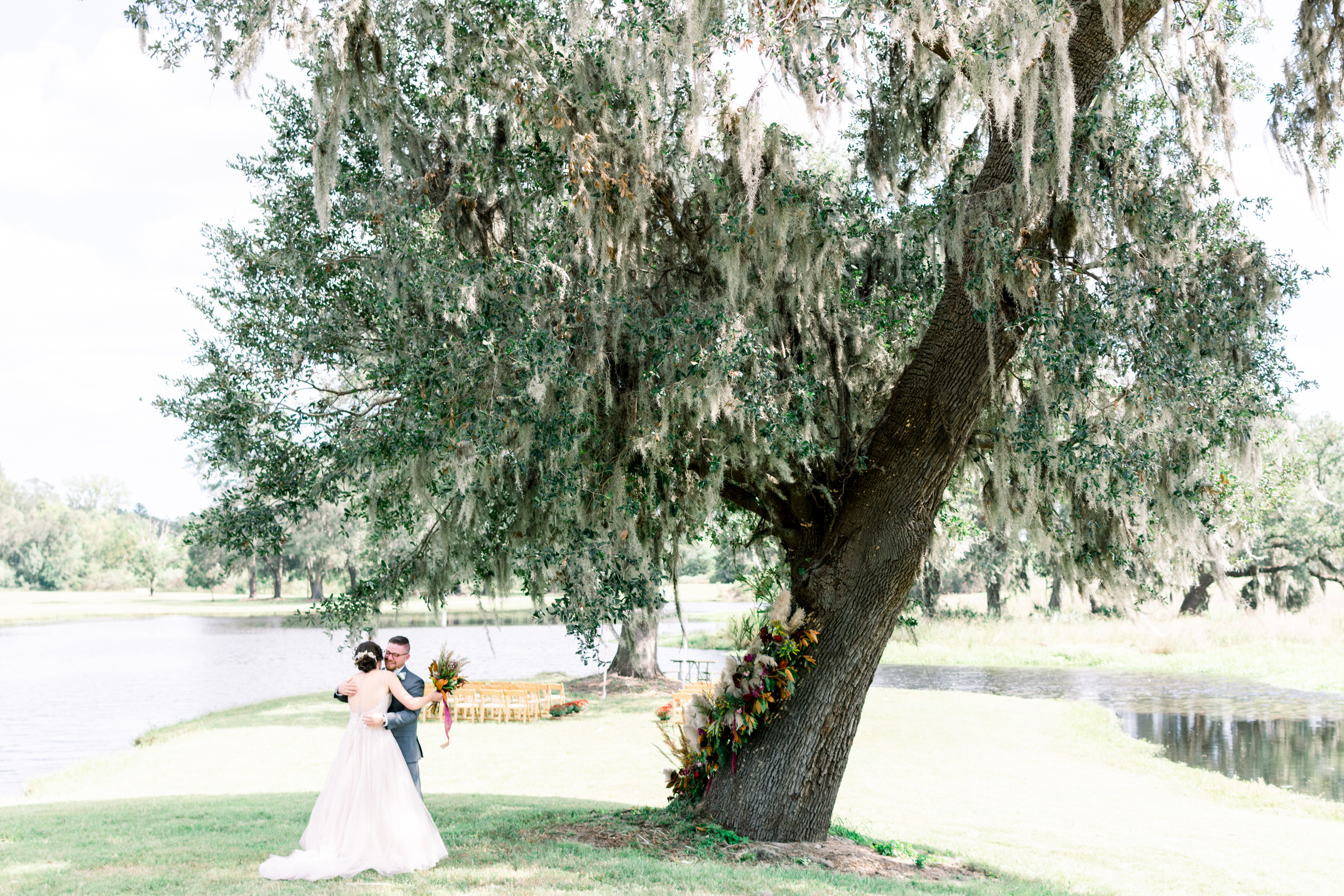 bride and groom under a live oak tree