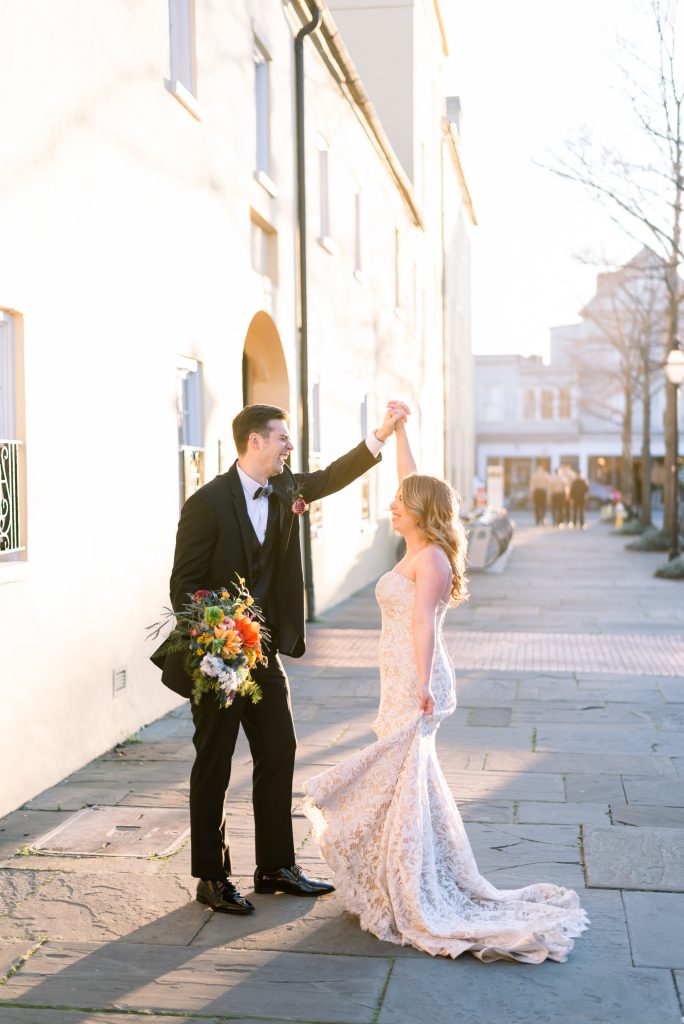 bride and groom dancing on cobblestone