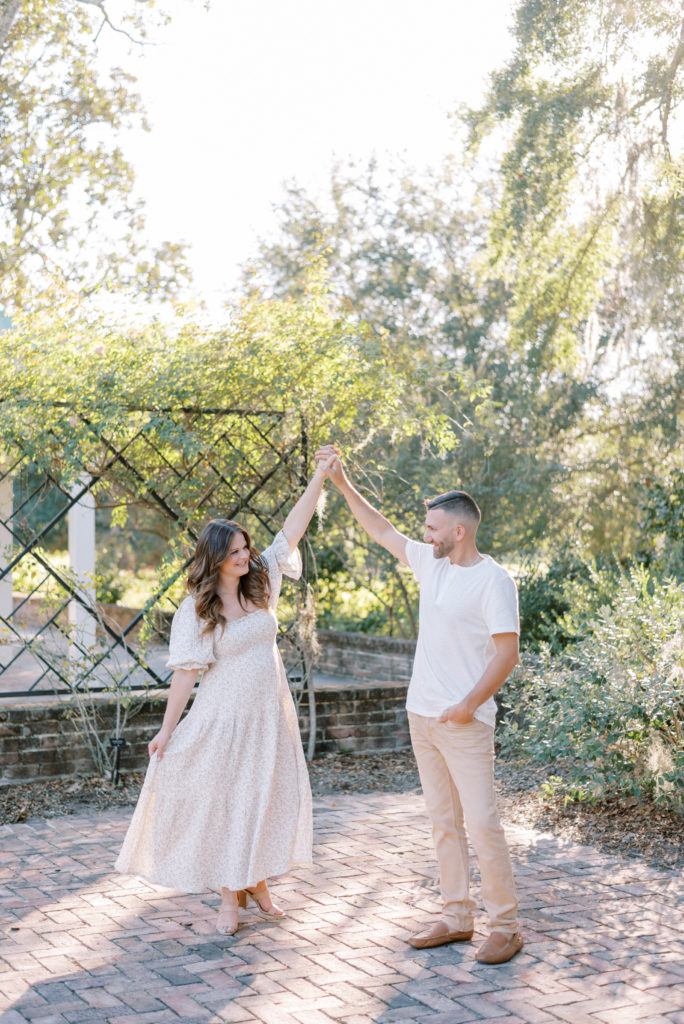 couple dancing during engagement photos in Hampton Park South Carolina
