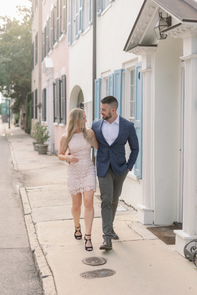 Engaged couple wearing formal clothes on Tradd Street in Historic Downtown Charleston
