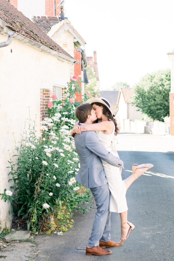 Couple kissing in the road in Normandy