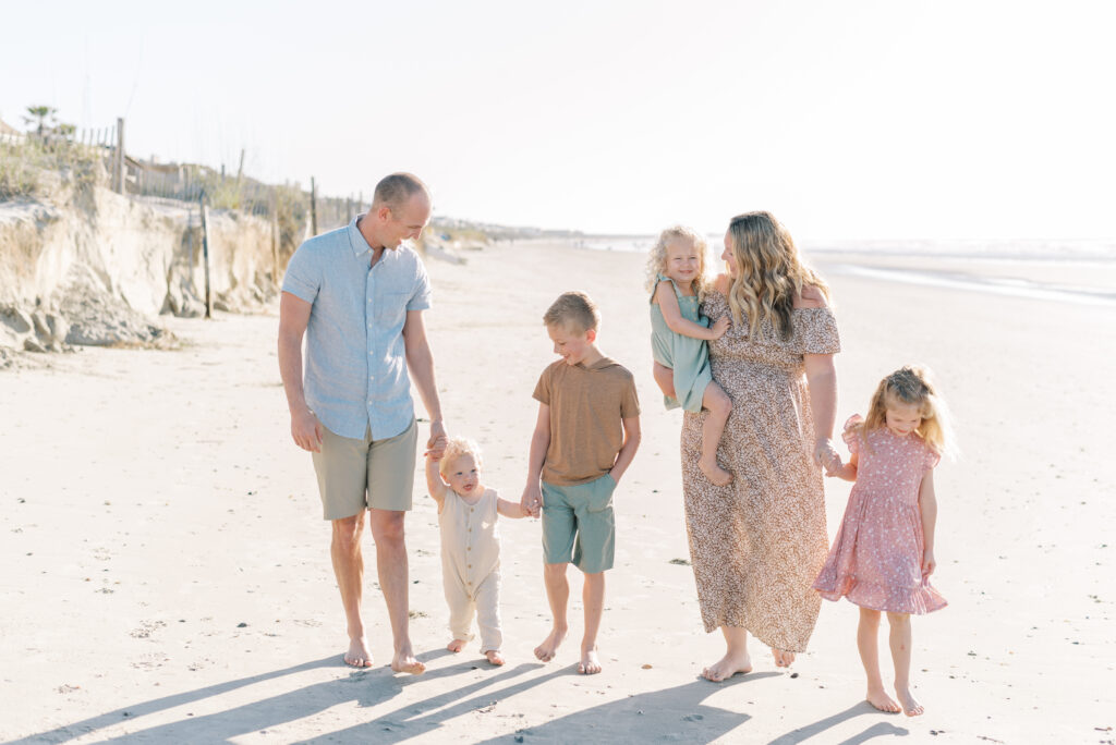 Family walking on a sunny evening at Isle of Palms beach in Charleston captured by Kelsey Halm Photography