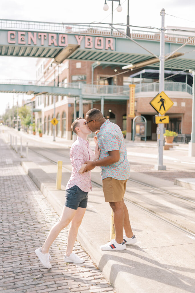 gay couple share a kiss under the centro ybor sign