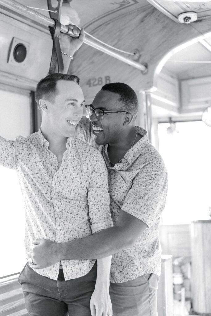 black and white portrait of couple hugging while riding the trolley