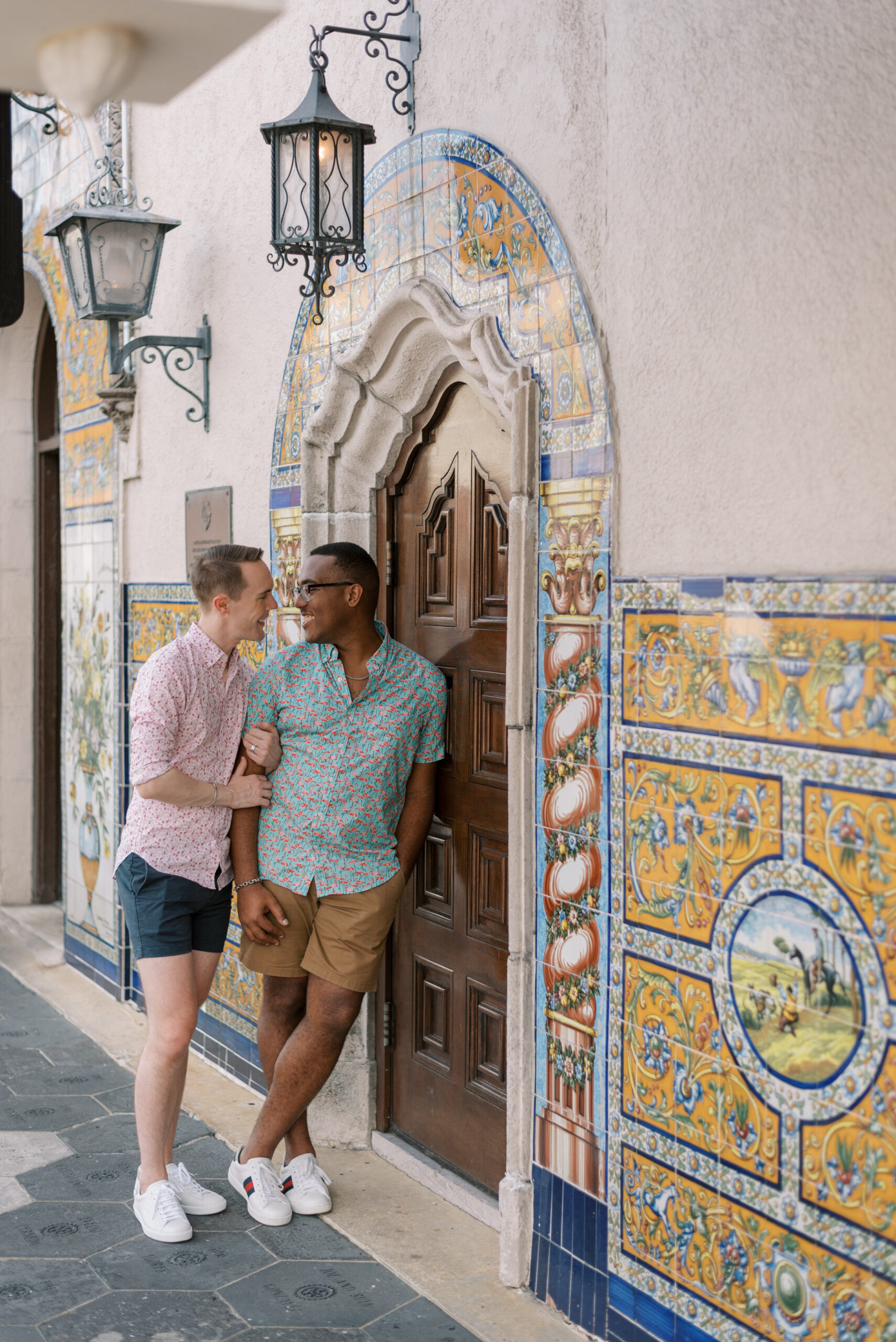 Husbands lean against an ornate doorway in Ybor City
