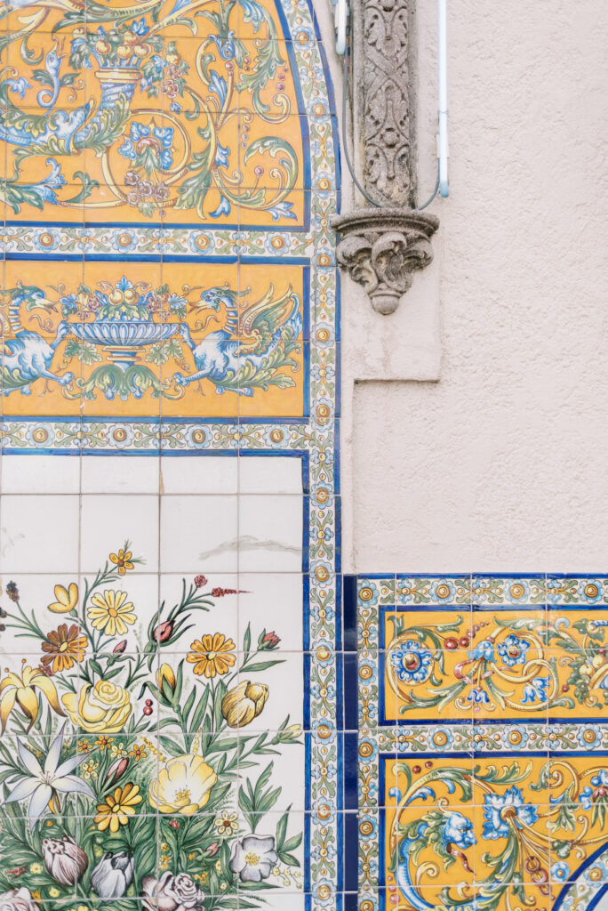 blue and yellow tile on a wall with birds and flowers