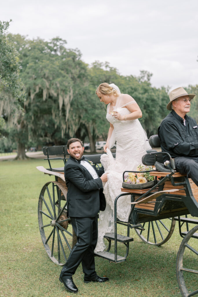 Groom helps his bride down from the carriage at Middleton Place