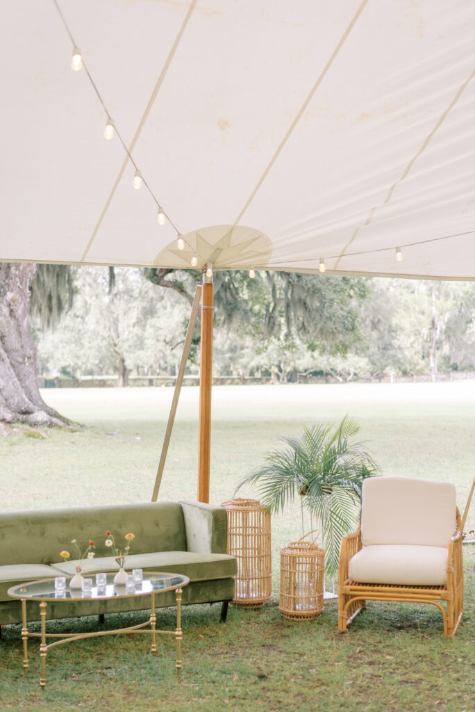 Modern lounge furniture under a sailcloth tent with string lights 