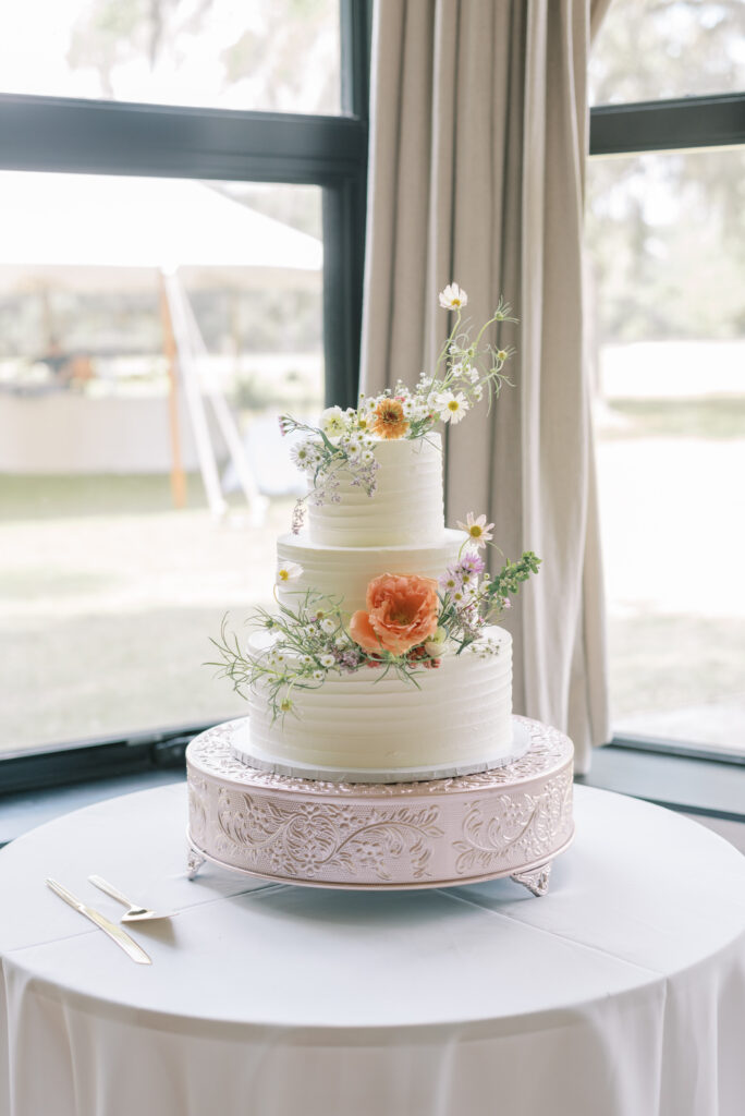 White cake topped with summery pastel florals