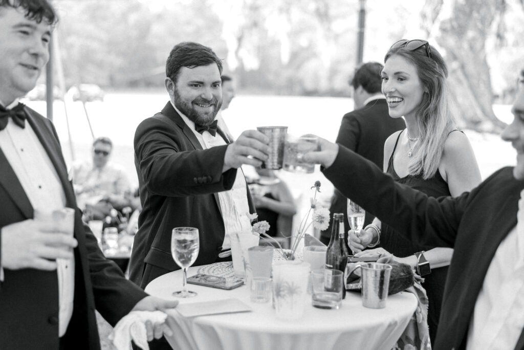 Groom shares a toast with guests at his wedding reception