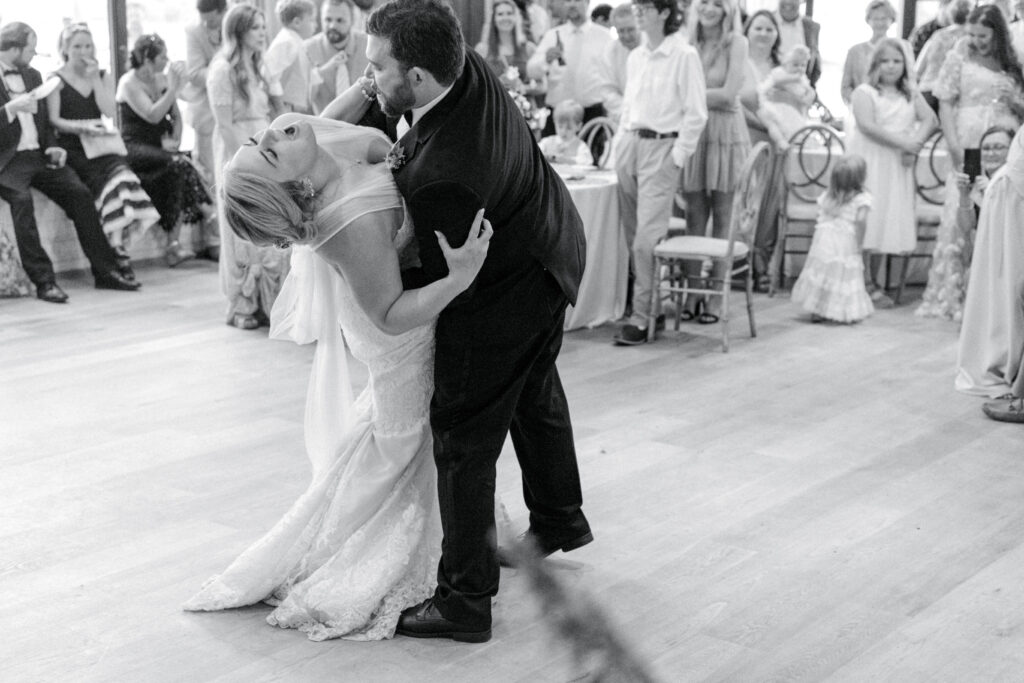 Groom dips bride during their first dance at Middleton Place