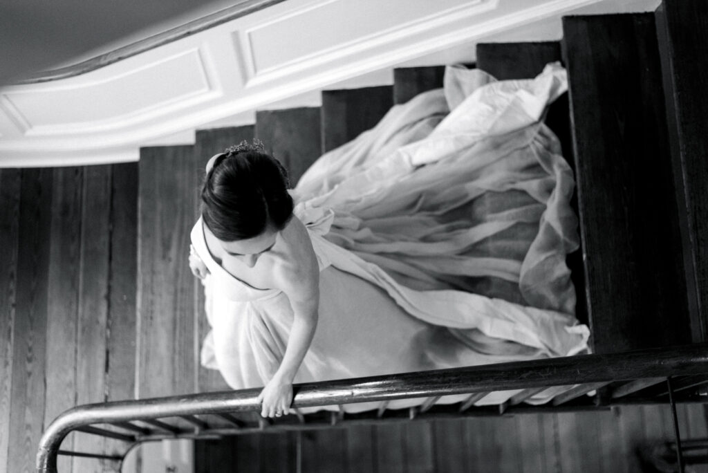 Bride walking down a staircase at The William Aiken House