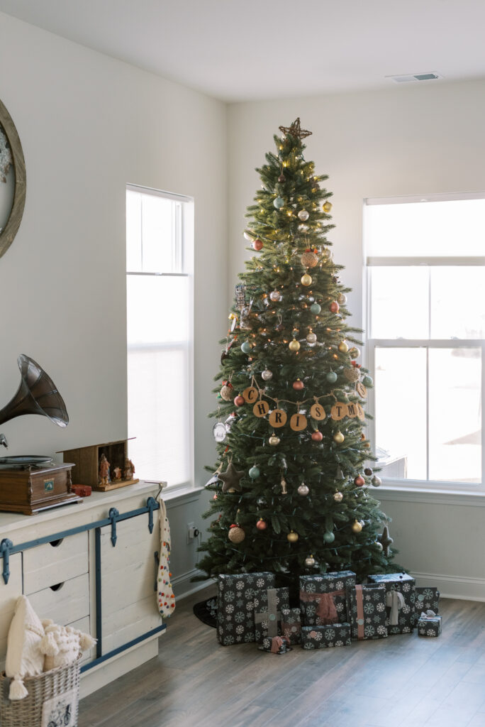 Christmas tree decorated with gray and blush gifts and neutral theme