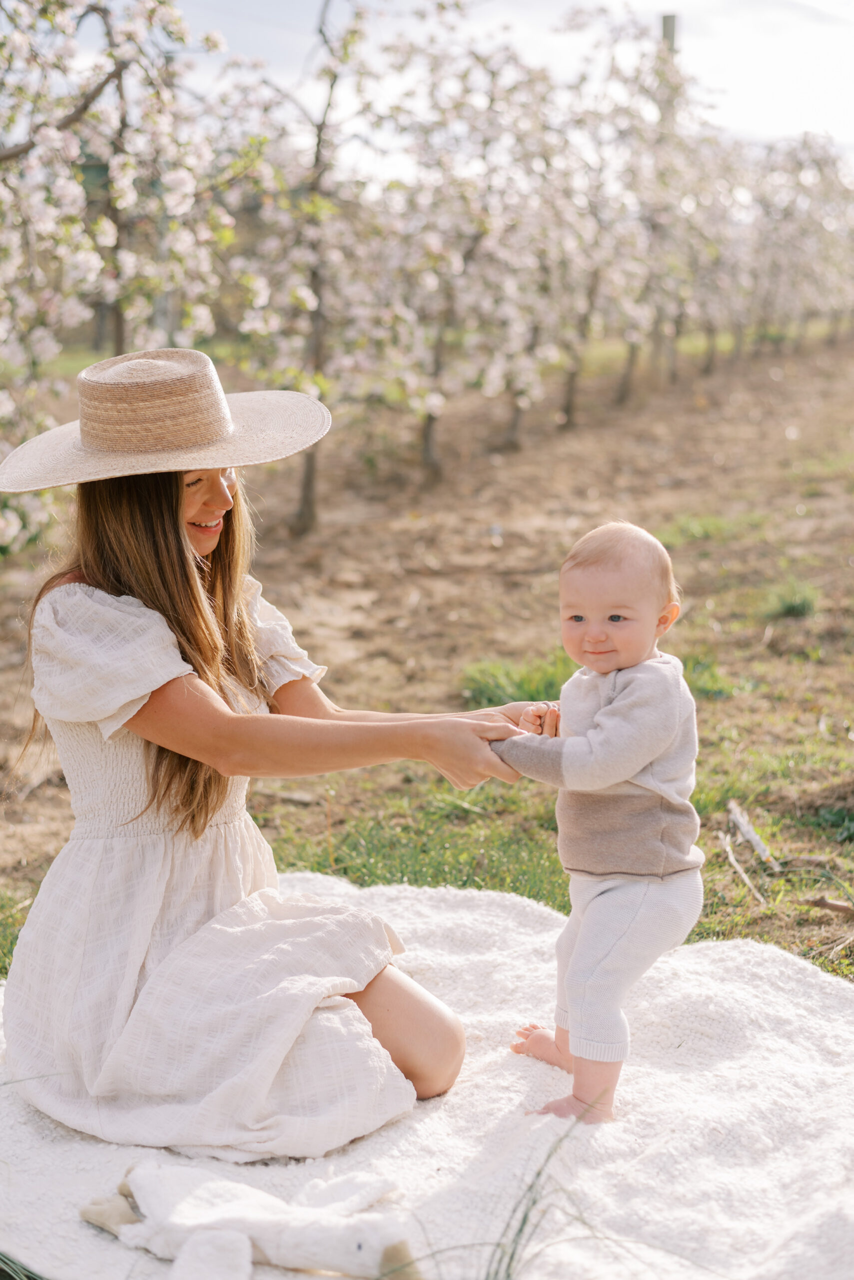 mommy and me photos in a blooming apple orchard