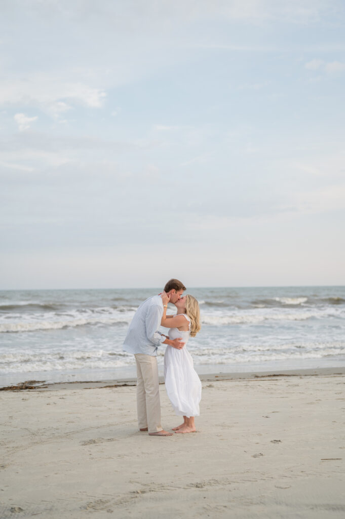 Couple celebrating a surprise proposal on a Charleston beach
