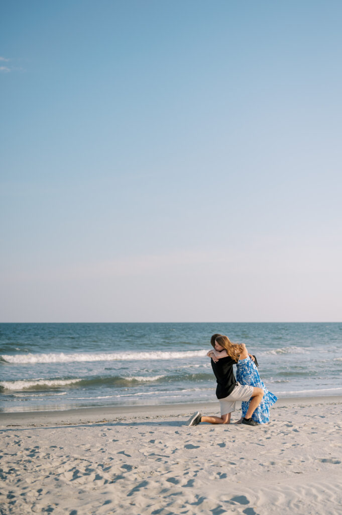 Man proposing to his girlfriend during a surprise engagement while Proposal Photographer of Charleston SC captures the special moment.