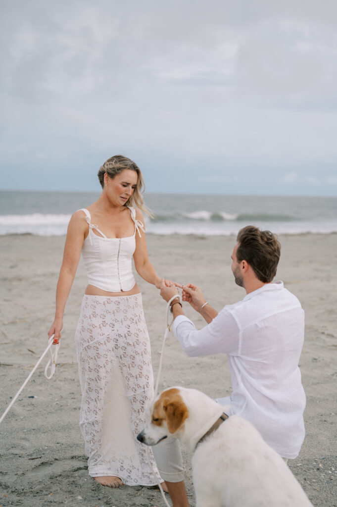 Man proposing to his girlfriend as Proposal Photographer of Charleston SC captures the surprise engagement.